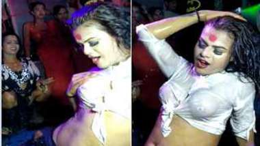 Excited Desi dancer covered in water during an XXX show in the club